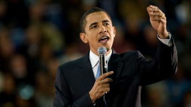 A photograph of former US president Barack Obama delivering a speech. 
