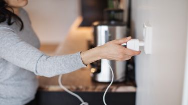 a woman plugs in a device