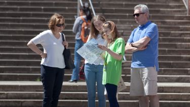 A student ambassador gives directions to a family outside Firth Court. 