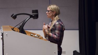 A presenter speaking to the audience at the Global Journalism Film Festival. 