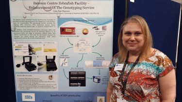 A member of the Bateson Centre stood with her prize winning poster