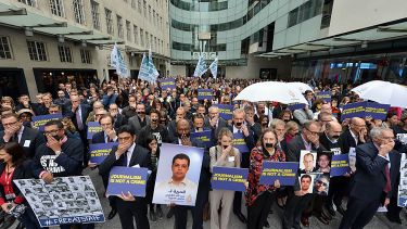 Journalists cover their mouths outside the BBC’s Broadcasting House at a BBC and CFOM hosted a conference.