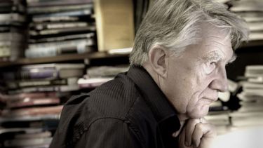 Ron Johnston in his office surrounded by books