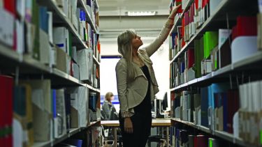 A reader perusing the book shelves.