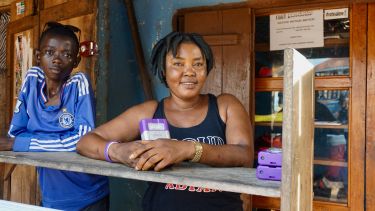 a woman and a child hold a battery pack