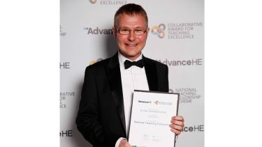 Gary Wood holding his award certificate