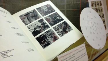 An image of an open book inside a display case.