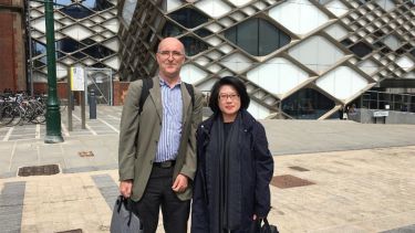 Academics Lenny Koh and Paul Sharrat stood in front of The Diamond building
