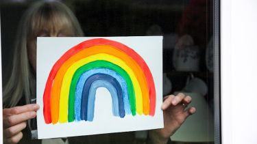A drawing of a rainbow in a window