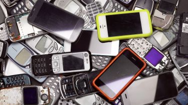 Old mobiles and smart phones in a pile