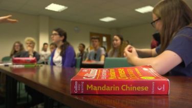 Mandarin Chinese book on a desk in a classroom