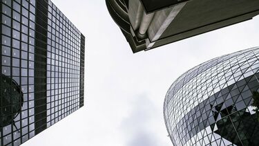 A view looking up at three skyscrapers