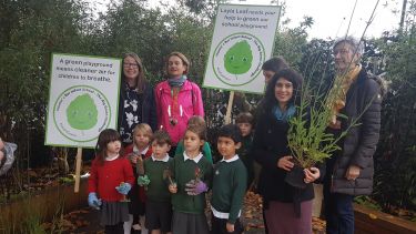 School children with signs displaying green symbols