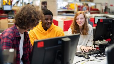 Group of students working together at some computers