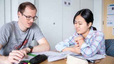 Two students work together in class