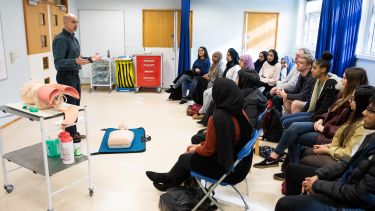 Medicine students listen to lecture in Clinical Skills setting