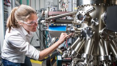 A scientist uses a Compound Semiconductor Molecular Beam Epitaxy System to grow semiconductor samples
