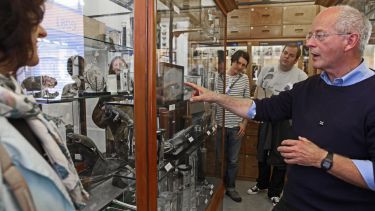 Professor Tim Birkhead talking about specimens in a display cabinet