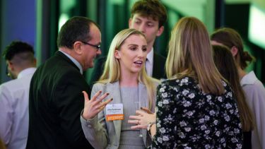 A Sheffield alum converses with students at a City Connections event