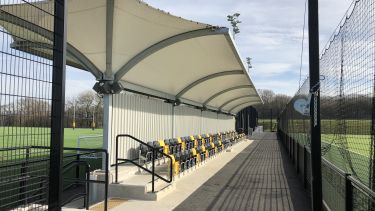 A seated spectator stand to the side of one of the Norton pitches