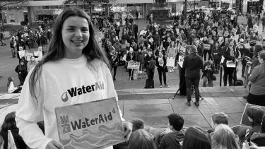 Samantha Hall with a Water Aid placard