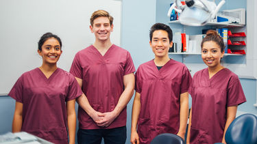 Smiling dental students, mix of male and female