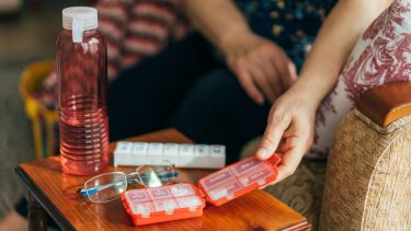 Senior Woman Holding Daily Pill Container