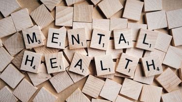 Scrabble pieces spelling out mental health