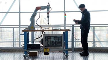 A man working with a collaborative robot at AMRC's Factory 2050
