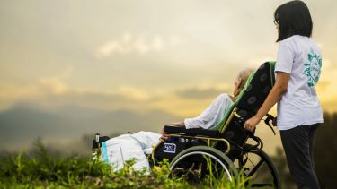 A care worker with a patient in wheelchair