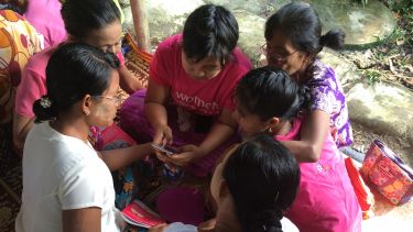 A group of women in Myanmar using an app