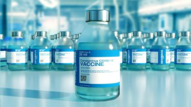 A row of vaccine bottles titled 'Coronavirus COVID-19 vaccine'
