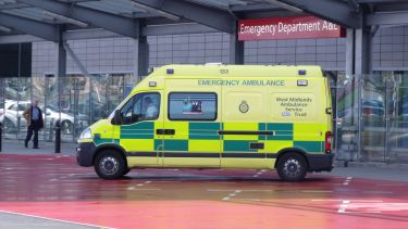 A yellow emergency ambulance stationed at Emergency Department