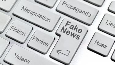 Graphic showing keyboard with fake news as a key on it