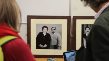 Visitors looking at a photo from the Hillfields, Coventry exhibit