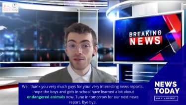 Student posing as news reader as part of a teaching English video