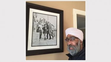 Mohan with the Blakemore original photo of his family 
