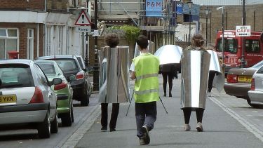 Young people walking down the street in costumes ready for filming