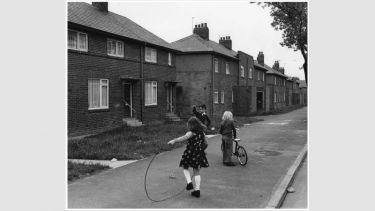 Children play in the open plan frontage of Ripley Avenue, North Meadow Well estate, North Shields.