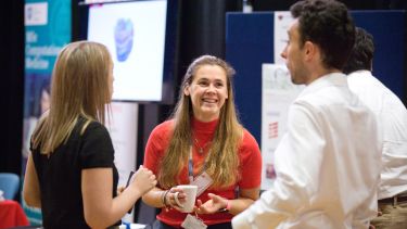 3 people having a conversation at the Insigneo showcase 2019.