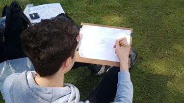 A physical geographer sketching the landscape.