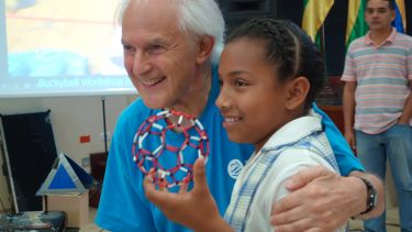 Harry Kroto with a child taking part in a Buckyball workshop.