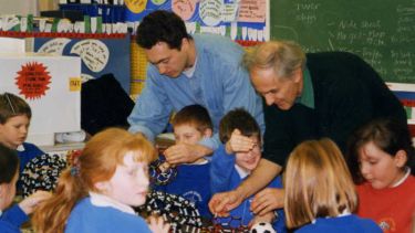 Harry Kroto and Jon Hare working with children