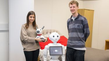 Two students with a robot