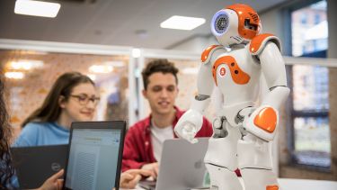 Robitics students and a small robot