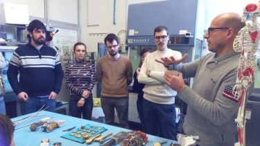 Luca Cristofolini explains biomechanical testing in the Biomechanics Laboratory to the Spinner fellows