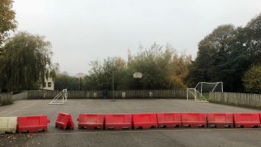 A school playground with barriers