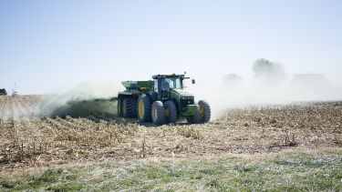 tractor spreading basalt rock dust in field