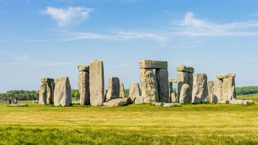 Stonehenge, showing the stone pillars against a blue sky