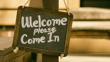Slate board saying welcome - please come in
